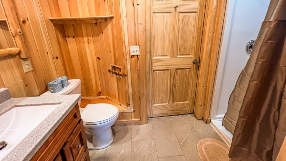Cabin Rental 10 Interior Bathroom Sink, Toilet, and Shower.