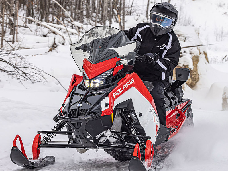 A Person Operating a Snowmobile in the Winter.